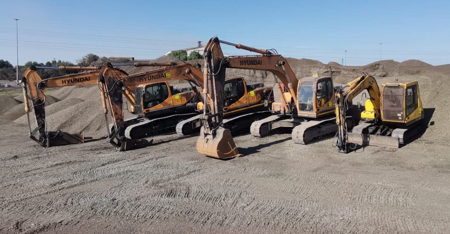 A row of excavators in the yard